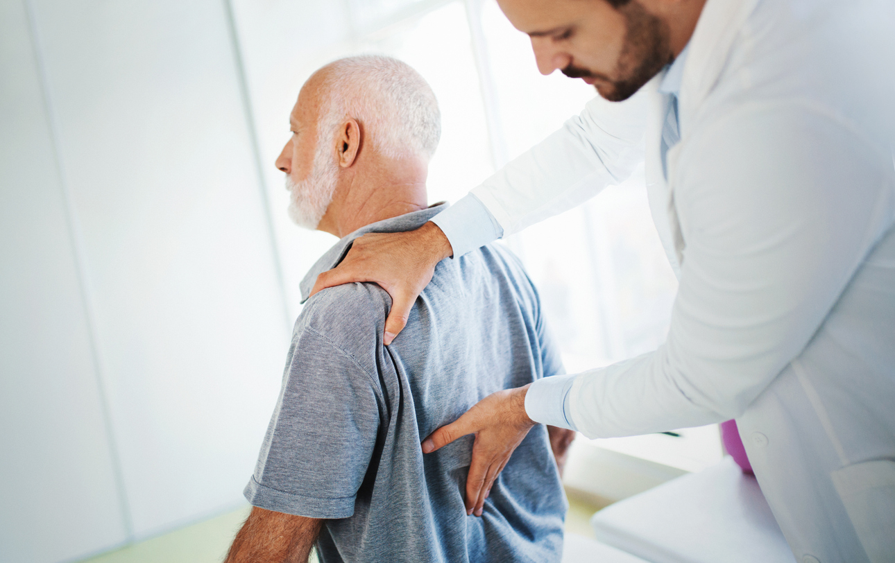 man and doctor with lumbar radiculopathy
