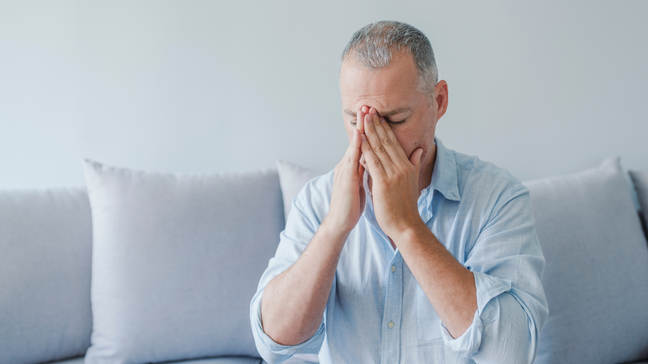 white male in blue shirt with chronic headaches